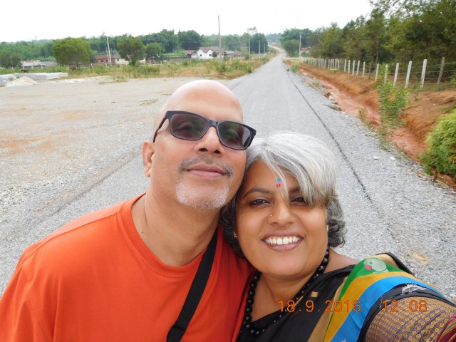 The selfie with the town in the background at the entrance to Site 2. 